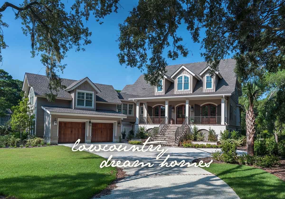 Lowcountry custom home with wraparound porches and a pool under a blue sky.