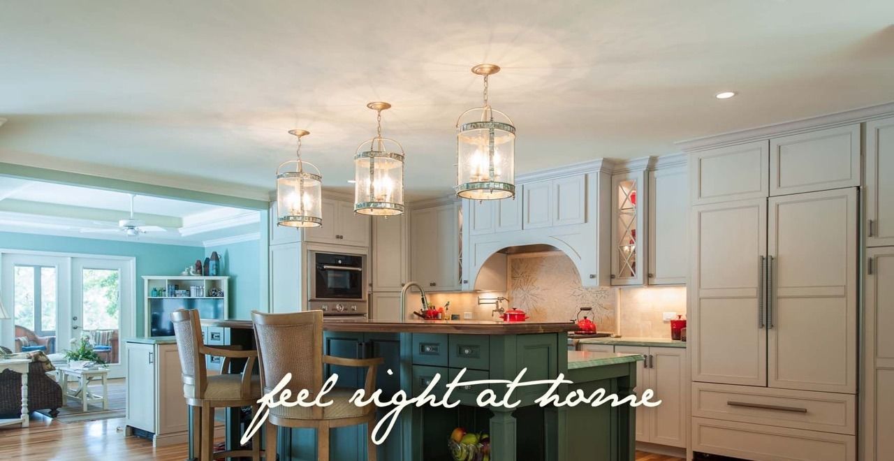 Custom kitchen with a green island, lantern pendants and a breakfast bar.